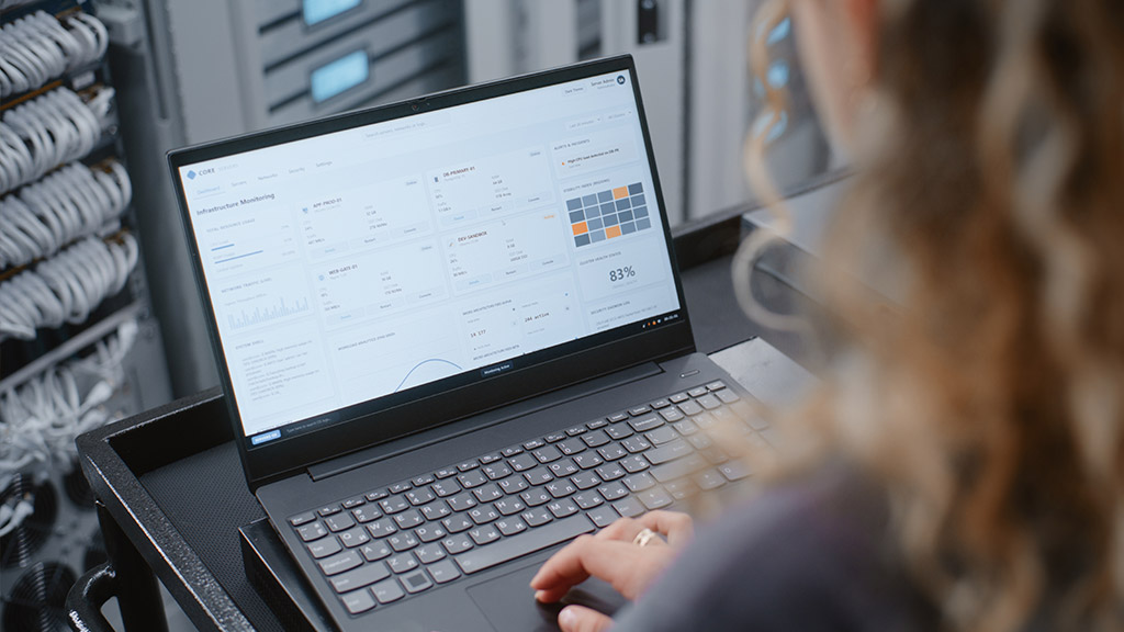 A person reviews website performance metrics on a laptop dashboard while diagnosing why a site is loading slowly.